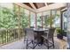 Screened in porch offers outdoor seating with a table, chairs and views of the landscape at 119 Florentino Ct, Clayton, NC 27527