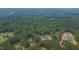 Aerial view showcasing a neighborhood immersed in a dense, lush forest landscape at 1210 Bayview Ct, Franklinton, NC 27525