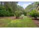 Back yard featuring lawn, trees, wooden deck, and a shed at 1210 Bayview Ct, Franklinton, NC 27525