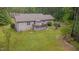 This backyard has a lush green lawn, mature trees providing shade, and serene natural surroundings at 1210 Bayview Ct, Franklinton, NC 27525