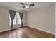 Bright bedroom features hardwood floors, a ceiling fan, and a window with curtain at 1210 Bayview Ct, Franklinton, NC 27525