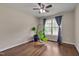 Hardwood floor bedroom featuring a large window with curtains and a potted plant at 1210 Bayview Ct, Franklinton, NC 27525