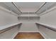 Walk-in closet featuring hardwood floors and shelving along all walls at 1210 Bayview Ct, Franklinton, NC 27525