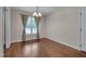 Comfortable dining area with hardwood floors, bright window, and classic chandelier at 1210 Bayview Ct, Franklinton, NC 27525