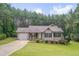 Charming single-story home with manicured lawn, attached garage, and welcoming front porch at 1210 Bayview Ct, Franklinton, NC 27525