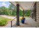 Covered porch featuring black columns and colorful potted plants adding curb appeal at 1210 Bayview Ct, Franklinton, NC 27525