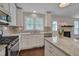 View of kitchen with stainless appliances, granite countertops, and tiled backsplash at 1210 Bayview Ct, Franklinton, NC 27525