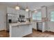 Bright kitchen boasts white cabinets, stainless steel appliances, granite counters and backsplash at 1210 Bayview Ct, Franklinton, NC 27525