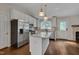 Modern kitchen featuring white cabinets, stainless steel appliances, and a granite-topped island at 1210 Bayview Ct, Franklinton, NC 27525