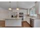 An open kitchen features white cabinets, a center island, stainless appliances, and granite countertops at 1210 Bayview Ct, Franklinton, NC 27525