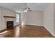 Sun-lit living room with wood floors and stone fireplace at 1210 Bayview Ct, Franklinton, NC 27525