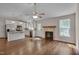 Spacious, open-concept living area featuring wood floors, fireplace, and well-lit kitchen at 1210 Bayview Ct, Franklinton, NC 27525