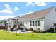 Backyard with a patio, fire pit, lush lawn, and manicured landscaping, perfect for outdoor entertaining at 1217 Clandon Square Rd, Hillsborough, NC 27278