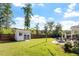 Lush backyard featuring a storage shed, patio with fire pit, and ample green space for outdoor activities at 1217 Clandon Square Rd, Hillsborough, NC 27278