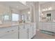Bathroom featuring double vanities with granite countertops, ample storage, and modern fixtures at 1217 Clandon Square Rd, Hillsborough, NC 27278