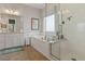 Bright bathroom with a soaking tub, separate glass shower, and dual vanities with ample counter space at 1217 Clandon Square Rd, Hillsborough, NC 27278