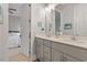 Bathroom featuring a double sink vanity with neutral cabinets, a large mirror, and modern fixtures at 1217 Clandon Square Rd, Hillsborough, NC 27278