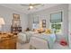 Comfortable bedroom featuring two twin beds, natural light from windows, and a ceiling fan at 1217 Clandon Square Rd, Hillsborough, NC 27278