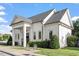 Elegant community clubhouse featuring white siding, a covered entrance, and well-maintained landscaping at 1217 Clandon Square Rd, Hillsborough, NC 27278