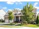 Attractive brick home with a well-kept lawn, a two-car garage, and a welcoming front porch at 1217 Clandon Square Rd, Hillsborough, NC 27278