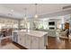 Open concept kitchen featuring a large island and seamlessly flowing into the dining and living areas at 1217 Clandon Square Rd, Hillsborough, NC 27278