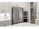 A bright kitchen with white cabinets, stainless steel refrigerator, and a built-in microwave at 1217 Clandon Square Rd, Hillsborough, NC 27278