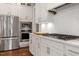Well-equipped kitchen with stainless steel appliances, white cabinetry, and a gas cooktop with a modern range hood at 1217 Clandon Square Rd, Hillsborough, NC 27278