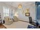 Bright living room with neutral walls, comfortable seating, a built-in desk, and modern light fixtures at 1217 Clandon Square Rd, Hillsborough, NC 27278