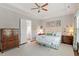 Light-filled main bedroom with tray ceiling, hardwood floors, and neutral decor, adjacent to the bathroom at 1217 Clandon Square Rd, Hillsborough, NC 27278