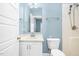Bathroom featuring light blue walls, a vanity with white cabinets, and shower with updated fixtures at 1230 Sykes Rd, Spring Hope, NC 27882