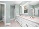 Bathroom features double sinks, large mirrors, and tiled floors at 1230 Sykes Rd, Spring Hope, NC 27882