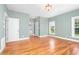 Spacious bedroom with hardwood floors, three doorways, and large windows for natural light at 1230 Sykes Rd, Spring Hope, NC 27882