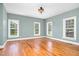 Bedroom featuring three large windows, hardwood floors and light green walls at 1230 Sykes Rd, Spring Hope, NC 27882