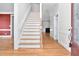 Inviting foyer featuring hardwood floors and staircase, complemented by neutral wall paint at 1230 Sykes Rd, Spring Hope, NC 27882