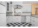 Bright kitchen with granite counters, stainless appliances, and black & white checkered floors at 1230 Sykes Rd, Spring Hope, NC 27882