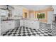 Charming kitchen with checkered floors, granite countertops, and ample storage space at 1230 Sykes Rd, Spring Hope, NC 27882