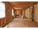 View of a large unfinished room with exposed wood framework and a staircase, ready for customization at 1230 Sykes Rd, Spring Hope, NC 27882