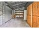 Interior of a spacious workshop, featuring a workbench and shelving, providing ample space for projects at 1230 Sykes Rd, Spring Hope, NC 27882