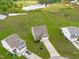 Stunning aerial view with a lush yard, a tranquil lake, and a long driveway approach at 124 Lahinch Dr, Fuquay Varina, NC 27526