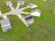 Aerial view of a home with solar panels surrounded by green spaces in a suburban neighborhood at 124 Lahinch Dr, Fuquay Varina, NC 27526