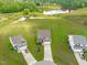 Breathtaking aerial view of a home, pond, and verdant surroundings with long driveways at 124 Lahinch Dr, Fuquay Varina, NC 27526