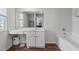 This bright bathroom features a soaking tub, stylish vanity, and great natural light at 124 Lahinch Dr, Fuquay Varina, NC 27526