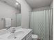 This bright bathroom features modern fixtures, large mirror, and a neutral color palette at 124 Lahinch Dr, Fuquay Varina, NC 27526