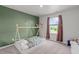 Cozy bedroom showcasing an accent wall, natural light, and plush carpet for a warm atmosphere at 124 Lahinch Dr, Fuquay Varina, NC 27526