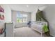 A charming Bedroom featuring a large window, plush carpet, and a neutral color palette at 124 Lahinch Dr, Fuquay Varina, NC 27526