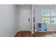 Bright entryway with hardwood floors, featuring a white door and a window with a view to the front yard at 124 Lahinch Dr, Fuquay Varina, NC 27526