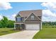 Charming two-story home with a well-kept lawn and a convenient two-car garage with ample parking space at 124 Lahinch Dr, Fuquay Varina, NC 27526
