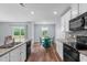 Bright kitchen features stainless appliances, tile backsplash, granite countertops, and breakfast nook at 124 Lahinch Dr, Fuquay Varina, NC 27526