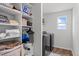 Well-lit laundry room features modern appliances and ample storage shelves for convenience at 124 Lahinch Dr, Fuquay Varina, NC 27526