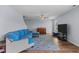 Comfortable living room with plush blue sectional sofa and stylish area rug on wood flooring at 124 Lahinch Dr, Fuquay Varina, NC 27526